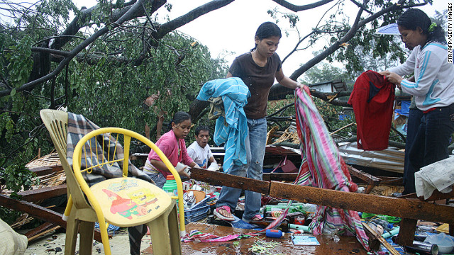 Residents gather their belongings after their house was destroyed by strong winds brought about by Typhoon Bophal earlier this month.
