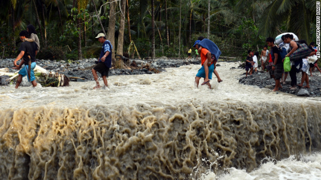 Residents cross a road destroyed at the height of Typhoon Bopha in the village of Andap, New Bataan township, Compostela Valley province on December 5.