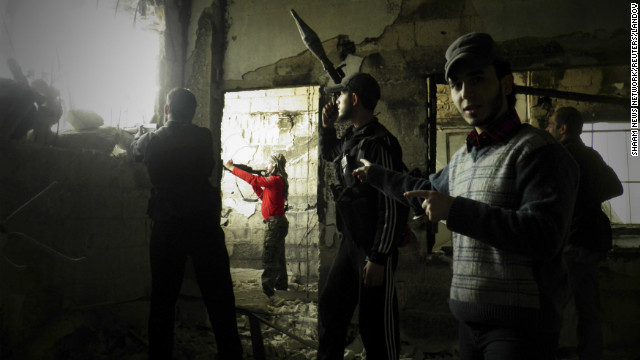 In this handout from the Shaam News Network, Free Syrian Army fighters stand guard against forces loyal to Syrian President Bashar al-Assad in the Al-khalidiya neighborhood of Homs on Tuesday, December 4. 