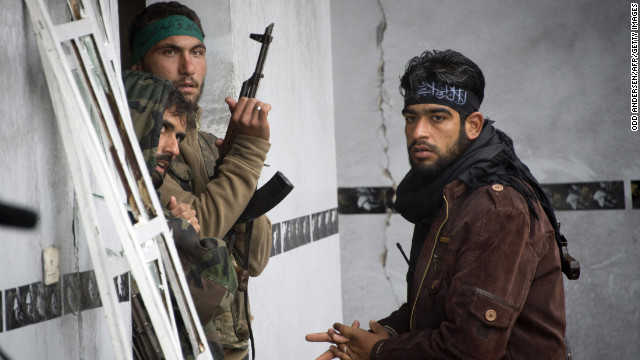 Rebel soldiers stand guard inside a building in Aleppo on December 6. 