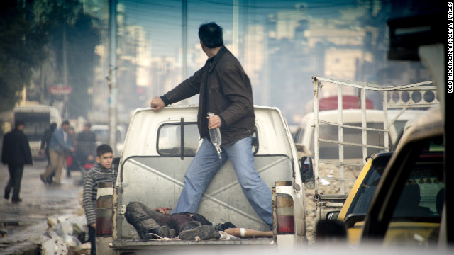 A wounded rebel fighter is transported to a hospital in the back of a truck in Aleppo, Syria, on Thursday, December 6. At least 23 people died in Syria on Thursday, most of them in Damascus and Aleppo, according to the opposition Local Coordination Committees of Syria. 