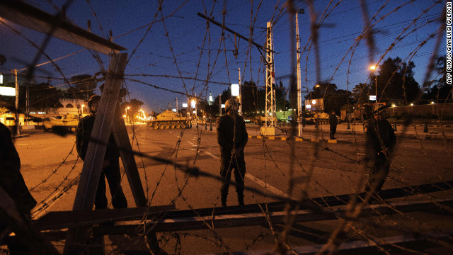 Egyptian soldiers stand outside the presidential palace in Cairo after setting up barbed wire barricades on December 6.