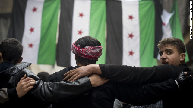 Rebel fighters take part in a demonstration against the Syrian regime after Friday prayers in Aleppo on December 7.