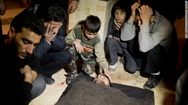 Syrians mourn a fallen fighter at a rebel base in the al-Fardos area of Aleppo on Saturday, December 8.