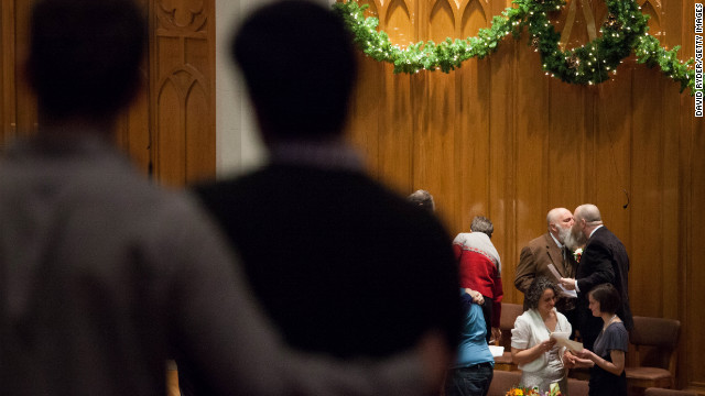 Larry Duncan and Randy Shepherd kiss at the end of a mass wedding for 25 couples in Seattle on December 9 in Seattle.