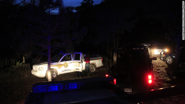 Forensic technicians arrive at a base set up by federal police near the plane crash site.