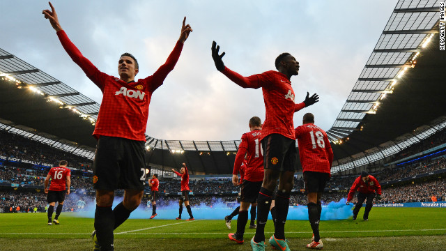 United's players celebrate Robin Van Persie's decisive late goal in a 3-2 victory -- which was met by missiles and smoke bombs hurled by City supporters.