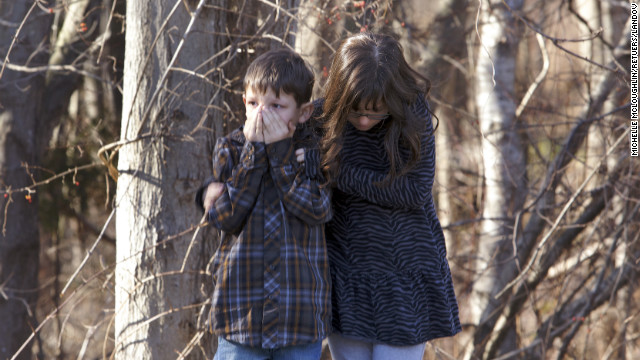 Children wait outside Sandy Hook Elementary School in Newtown, Connecticut, after the shooting.