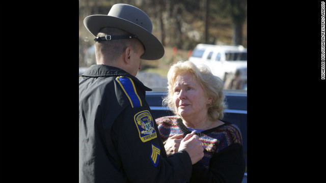 A woman speaks with a Connecticut state trooper outside Sandy Hook Elementary School on December 14.