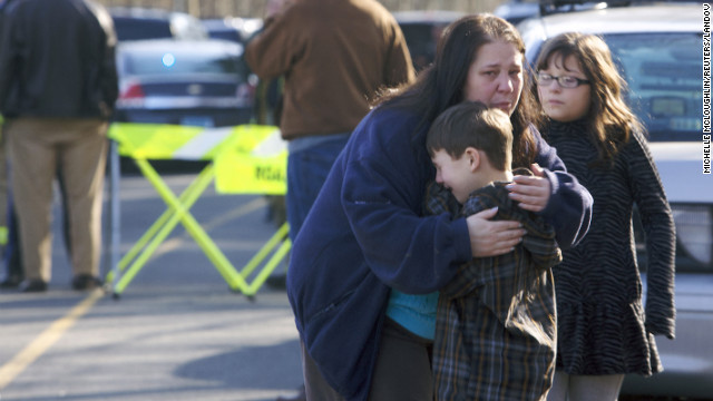 A young boy is comforted outside Sandy Hook Elementary School on December 14.