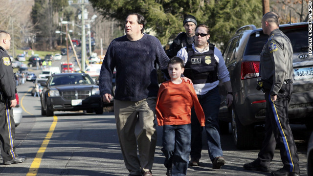 A man escorts his son away from Sandy Hook Elementary School on December 14.
