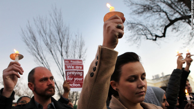Julie Henson of San Francisco joins other people outside the White House to participate in a candlelight vigil to remember the victims at the Sandy Hook Elementary School shooting in Newtown, Connecticut on December 14, 2012. According to reports, the gunman killed 20 children and six adults.