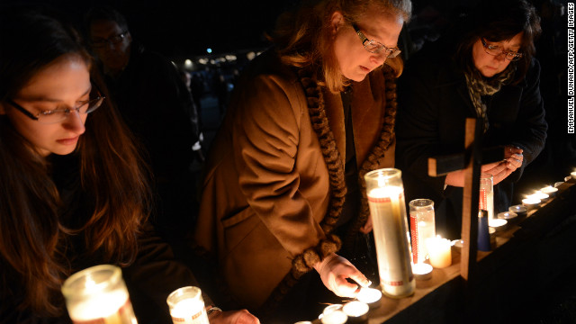 People gather for a prayer vigil at St. Rose Church in Newtown on December 14.