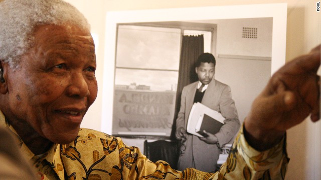 Mandela shows something to a group of international journalists visiting the Nelson Mandela Foundation in Johannesburg in May 2004.