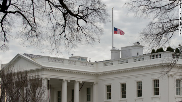 The U.S. flag flies at half-staff above the White House on December 15.