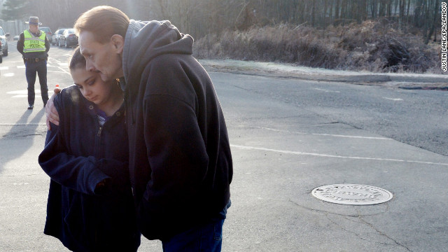 Ken Kowalsky and his daughter Rebecca, 13, embrace while standing at the end of the road leading to Sandy Hook Elementary School on December 15.