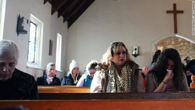 People attend a prayer service in Newtown on Saturday to reflect.