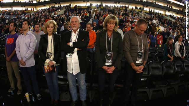 Fans at the NBA game between the Utah Jazz and the Phoenix Suns participate in a moment of silence for the victims of the Newtown shooting on Friday in Phoenix.
