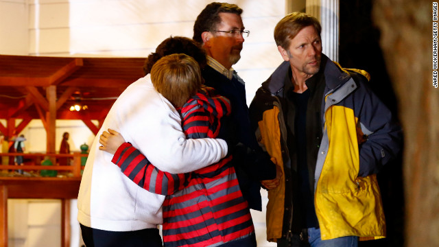 People hug outside of the Newtown United Methodist Church on December 14, in Newtown, Connecticut, near the site of the shootings at the Sandy Hook Elementary School.