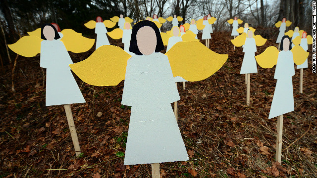 Angel wood cutouts for each of the 27 victims are set up on hillside in Newtown on December 16.