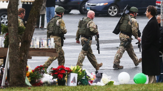 Connecticut State Police officers search outside St. Rose of Lima Roman Catholic Church in Newtown, Connecticut, on Sunday, December 16, after a threat prompted authorities to evacuate the building. Investigators found nothing to substantiate the reported threat, a police official said, declining to provide additional details. The church held Sunday services following last week's mass shooting at Sandy Hook Elementary School in Newtown.