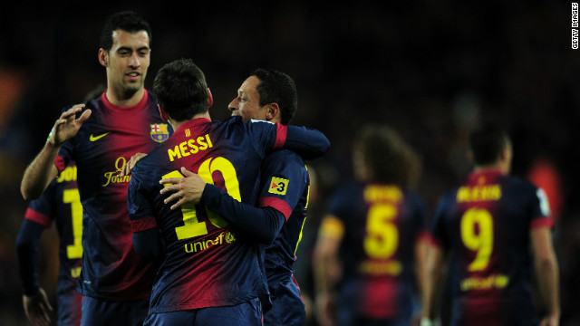 Messi celebrates with fellow goalscorers Busquets and Adriano as Barca move into a 3-1 lead at Camp Nou.