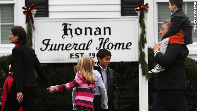 People walk to Honan Funeral Home before the funeral for 6-year-old Jack Pinto on December 17 in Newtown, Connecticut.