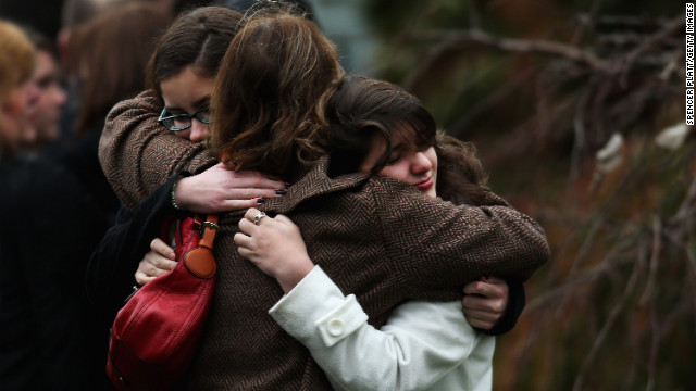 Three women embrace as they arrive for the funeral services for Noah Pozner on December 17.