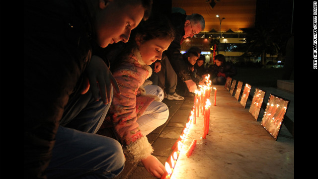 Children light candles to pay their respects to the victims of the Newtown, Connecticut, shooting at the main square in Tirana, Albania, on Monday, December 17. The deadly gun rampage at Sandy Hook Elementary School has provoked strong reactions from around the world.