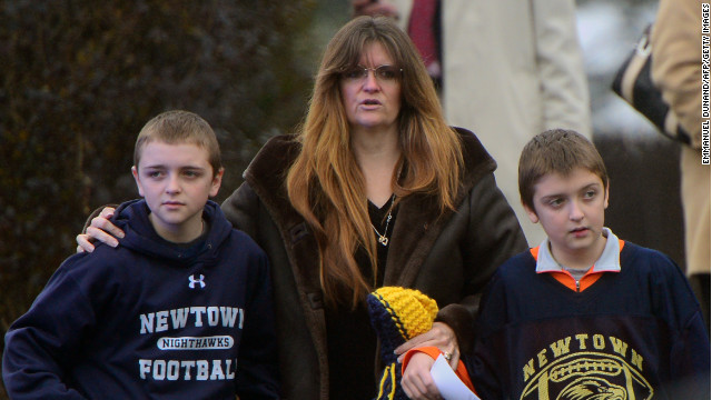 A mother and two children attend the funeral for Jack Pinto on December 17. Children are among those crowding the funeral for the 6-year-old boy.