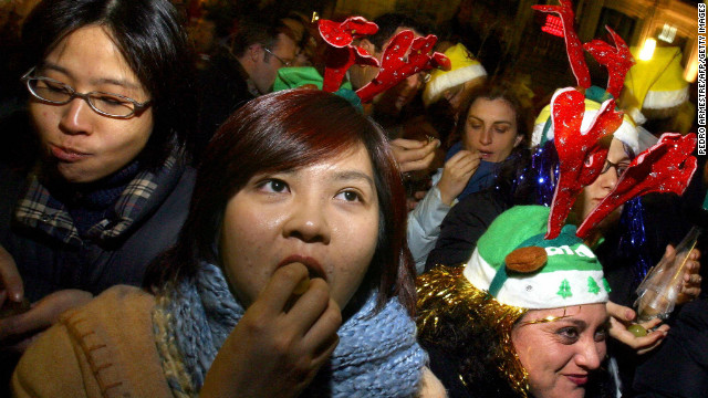 A crowd of people gathered in Puerta del Sol in Madrid stuff their faces with 12 grapes to celebrate the New Year, each representing a month in the year ahead. Similar grape-related larks are practiced in Mexico, Chile and Costa Rica