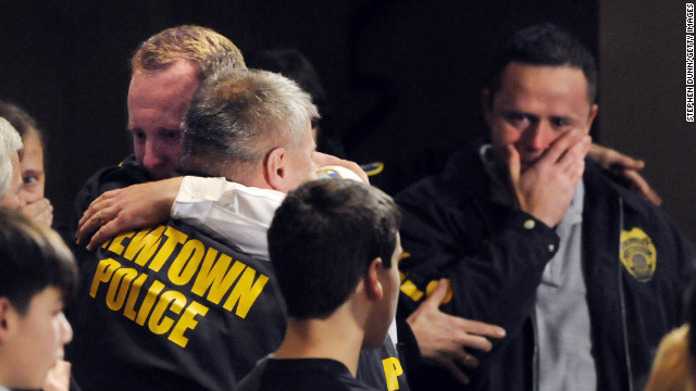 Newtown, Connecticut, first responders received an emotional standing ovation at a vigil for the school shooting victims on December 16.