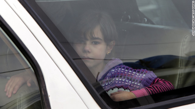 A child sits in the back of a vehicle at the border crossing leading to Masnaa, Lebanon, as people wait to stamp their documents before leaving Syria on December 19. Click through to view images from Syria from December, or see photos of the conflict from November.