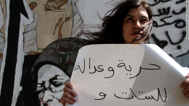 A protester holds a sign reading "freedom and justice for women and men" during a demonstration against sexual harassment in Cairo, Egypt, on July 6, 2012.