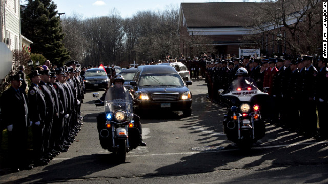 Police escort the hearse bearing the casket of Daniel Barden from St. Rose of Lima Church on December 19.