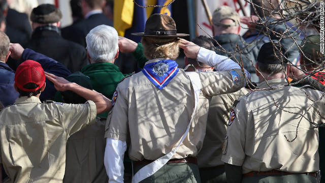 Boy scouts salute as a funeral procession for Benjamin Wheeler enters the Trinity Episcopal Church on December 20, in Newtown, Connecticut.