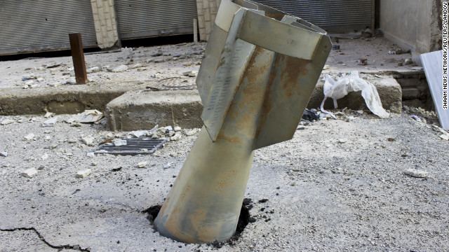 An unexploded bomb is seen lodged in a street in Ghouta, east of Damascus, Syria, Wednesday, December 19.