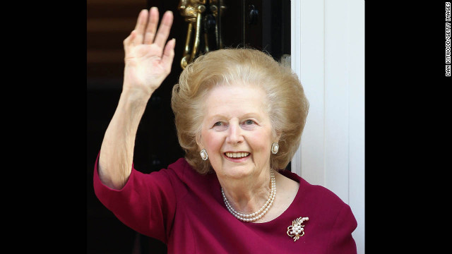 Thatcher waves to journalists from her London home after another hospital visit -- this time with a bout of flu -- in November 2010.