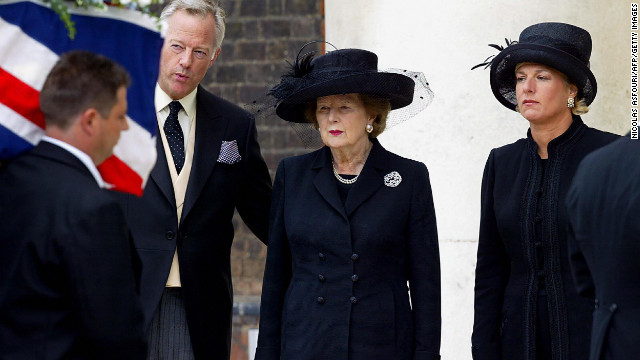 Thatcher, with her son, Mark, and her daughter, Carol, watches the coffin of her husband, Denis, during his funeral in July 2003 in London. Denis Thatcher died at age 88.