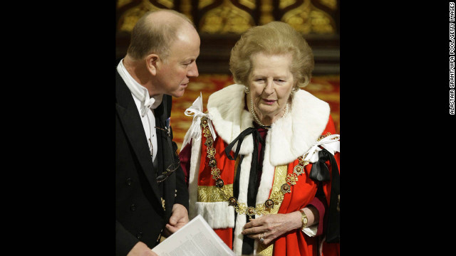 An usher helps Thatcher, now a baroness, to her seat during the state opening of Parliament in November 2009.