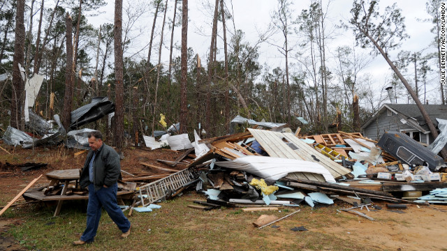 Home owner Mike Nichols surveys damage caused by a tornado that hit his home near Troy, Alabama, on December 26.