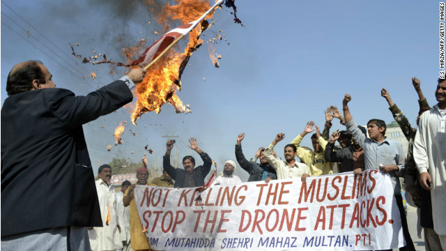 A Pakistani protester holds a burning U.S. flag as they shout slogans during a protest in Multan in 2012 against the US drone attacks in the Pakistani tribal region. 