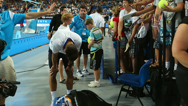 Novak Djokovic composes himself in the aftermath of an incident when a spectator barrier collapsed at the Hopman Cup.