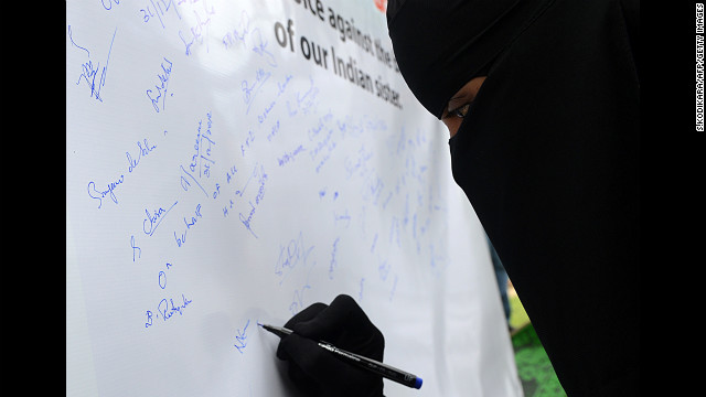 A Sri Lankan opposition United National Party activist places her signature on a banner in memory of the Indian gang-rape victim in Colombo on December 31.