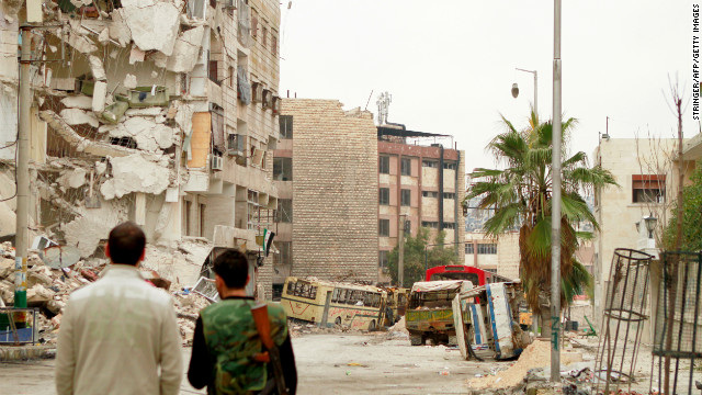 Rebel fighters inspect the debris on a street in the Bustan al-Basha district in the Syrian city of Aleppo on Tuesday, January 1. Click through to view images from Syria from December, or <a href='http://www.cnn.com/2012/12/04/middleeast/gallery/syria-unrest-november/index.html' target='_blank'>see photos of the conflict from November</a>.
