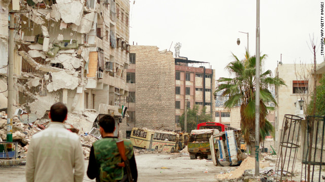 Rebel fighters inspect the debris on a street in the Bustan al-Basha district in the Syrian city of Aleppo on Tuesday, January 1. 