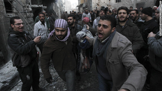 Syrians carry the body of a victim who activists said was killed during the bombing in the al-Ansari area of Aleppo, January 3.