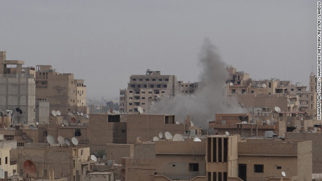 Smoke rises after what activists said was shelling by forces loyal to Syrian President Bashar al-Assad in Deir Al-Zor on Friday, January 4. 