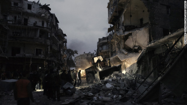 Syrians look for survivors amongst the rubble of a building targeted by a missile in the al-Mashhad neighborhood of Aleppo on Monday, January 7.
