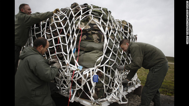 French soldiers prepare cargo for a British plane en route to Bamako on Sunday at the Evreux military base. 